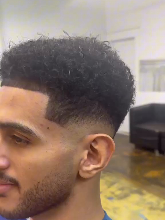 Curly top with a clean mid fade