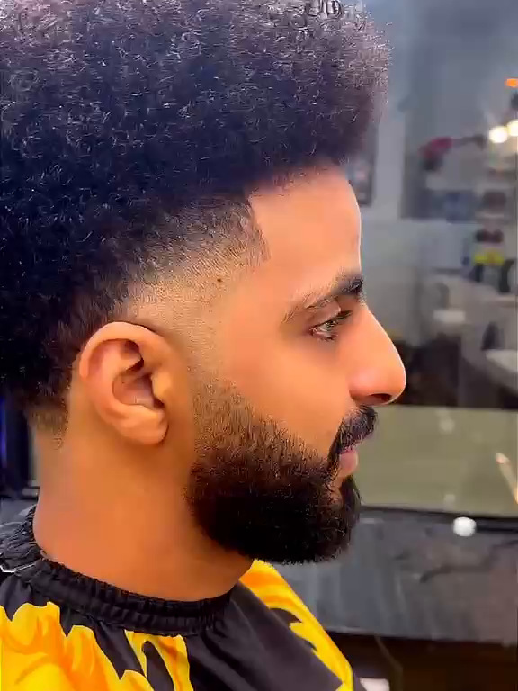 High-top afro with a sculpted beard
