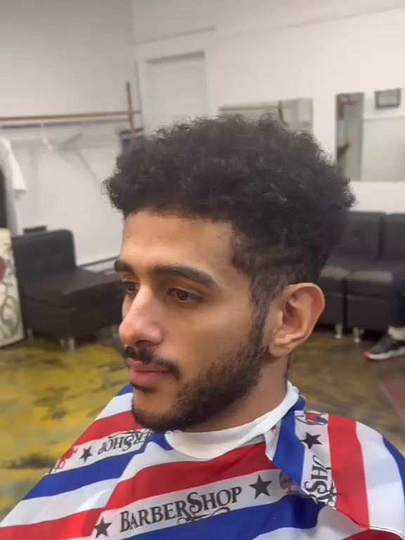 Curly top with a tapered skin fade